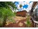 Relaxing backyard sanctuary showcasing rock garden, tropical plants and sitting area at 2638 Clarinet Dr, Orlando, FL 32837