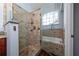 Modern bathroom featuring a large glass-enclosed shower with stone tile and a luxurious bathtub at 2638 Clarinet Dr, Orlando, FL 32837