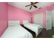 Bright bedroom with hardwood floors, ceiling fan, and closet, offering a cozy retreat with two beds at 2638 Clarinet Dr, Orlando, FL 32837