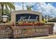 The Tanglewood neighborhood entrance sign is framed by colorful flowers and stately lantern fixtures at 2638 Clarinet Dr, Orlando, FL 32837