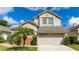 Lovely two-story home with a two-car garage and mature landscaping, providing a welcoming atmosphere at 2638 Clarinet Dr, Orlando, FL 32837