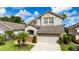 Beautiful two-story home featuring a spacious driveway and lush landscaping, enhancing its curb appeal at 2638 Clarinet Dr, Orlando, FL 32837