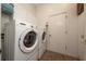 Functional laundry room with full-size washer and dryer, storage cabinets, and easy access to the outside at 2638 Clarinet Dr, Orlando, FL 32837