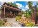 Outdoor patio with tropical plants, stone waterfall feature and covered dining area at 2638 Clarinet Dr, Orlando, FL 32837