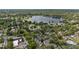 Aerial view of community near a serene lake surrounded by lush trees at 2719 Candlewood Ct, Apopka, FL 32703