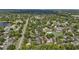 Aerial view of townhouse complex surrounded by lush greenery, and a community pool and tennis courts at 2719 Candlewood Ct, Apopka, FL 32703