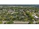 Aerial view of the townhouse complex surrounded by lush greenery, community pool and tennis courts at 2719 Candlewood Ct, Apopka, FL 32703