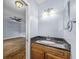 Bathroom vanity with black granite counters, wood cabinet, and attached bedroom at 2719 Candlewood Ct, Apopka, FL 32703
