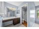 A bathroom with a light wood floor and a combination shower and tub at 2719 Candlewood Ct, Apopka, FL 32703