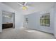 Bright bedroom with a ceiling fan and two large windows that allow natural light at 2719 Candlewood Ct, Apopka, FL 32703