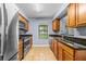 Galley kitchen featuring stainless steel appliances and granite countertops at 2719 Candlewood Ct, Apopka, FL 32703