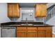 Kitchen featuring wood cabinets, granite countertops, and stainless steel sink and dishwasher at 2719 Candlewood Ct, Apopka, FL 32703