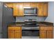 Updated kitchen with stainless steel appliances and warm wood cabinetry at 2719 Candlewood Ct, Apopka, FL 32703