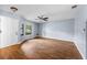 Bright, open living room with wood floors, ceiling fan, and bay window at 2719 Candlewood Ct, Apopka, FL 32703