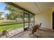 Chairs are set on a screened porch that overlooks a grassy backyard at 2719 Candlewood Ct, Apopka, FL 32703