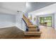 View of the carpeted staircase with white and blue banister leading to the upper level at 2719 Candlewood Ct, Apopka, FL 32703