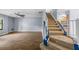 Carpeted staircase with white banister next to living room with wood floors at 2719 Candlewood Ct, Apopka, FL 32703