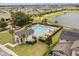 Community pool featuring a splash pad, lounge chairs and mature landscaping, perfect for relaxation at 2896 Matera Dr, St Cloud, FL 34771