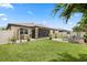 Spacious backyard featuring a covered patio, fire pit, and well-maintained lawn, perfect for outdoor enjoyment at 2896 Matera Dr, St Cloud, FL 34771