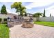 Private backyard with custom fire pit, lush landscaping and brick pavers offers a serene retreat at 2896 Matera Dr, St Cloud, FL 34771