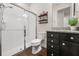 Bathroom features a walk-in shower, wood floors, and a modern vanity with granite countertops at 2896 Matera Dr, St Cloud, FL 34771