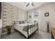 Bright bedroom features decorative wall, neutral color palette, and large window, for a peaceful retreat at 2896 Matera Dr, St Cloud, FL 34771