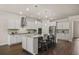 Modern kitchen featuring an island with bar seating, stainless steel appliances, and custom cabinetry at 2896 Matera Dr, St Cloud, FL 34771