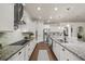 Well-lit kitchen with granite countertops, stainless steel appliances, hardwood flooring, and ample counter space at 2896 Matera Dr, St Cloud, FL 34771