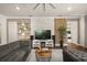 Inviting living room with decorative shelving, brick accent wall, hardwood floors, and plush seating at 2896 Matera Dr, St Cloud, FL 34771
