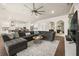 Spacious living room featuring hardwood floors, a large sectional sofa, and modern décor at 2896 Matera Dr, St Cloud, FL 34771