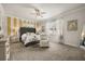 Serene main bedroom offers ample space, a stylish headboard, and a cozy sitting area for relaxation at 2896 Matera Dr, St Cloud, FL 34771