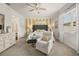 Bright main bedroom offers comfortable seating, a stylish color palette and a peaceful retreat at 2896 Matera Dr, St Cloud, FL 34771