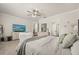 Bright main bedroom featuring neutral walls, decorative ceiling fan, and luxurious furnishings at 2896 Matera Dr, St Cloud, FL 34771