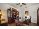Inviting office space features wood floors, built-in storage, and a glass-top desk for a productive work environment at 2896 Matera Dr, St Cloud, FL 34771