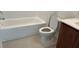 A functional bathroom with a toilet, tub-shower combo, and vanity with solid surface counter at 2971 Embark Trail, St Cloud, FL 34771