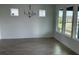 Airy dining area featuring tile floors, modern chandelier, and large windows offering plenty of natural light at 2971 Embark Trail, St Cloud, FL 34771