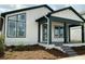 This charming single-story home features a covered porch, gray brick steps, and beautifully landscaped front yard at 2971 Embark Trail, St Cloud, FL 34771