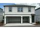 Two-story home exterior with two-car garage, a modern design, and a welcoming entrance at 2971 Embark Trail, St Cloud, FL 34771