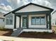 Stylish single-story home boasts a charming covered porch and complemented by modern design elements and landscaping at 2971 Embark Trail, St Cloud, FL 34771