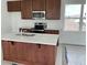 Modern kitchen with dark wood cabinets, stainless steel appliances, and a functional island at 2971 Embark Trail, St Cloud, FL 34771