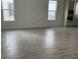 Bright, open-concept living space featuring neutral-toned tile flooring and large windows for ample natural light at 2971 Embark Trail, St Cloud, FL 34771