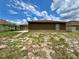 The backyard offers a blank canvas, featuring a freshly painted home and a spacious concrete patio at 306 Snook Way, Kissimmee, FL 34759