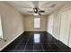 This spacious bedroom features stylish black tile flooring and a modern ceiling fan with lighting at 306 Snook Way, Kissimmee, FL 34759