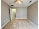 Bedroom featuring tile flooring, a ceiling fan, and an open doorway at 306 Snook Way, Kissimmee, FL 34759