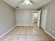 Bedroom featuring tile flooring, a ceiling fan, and an open doorway at 306 Snook Way, Kissimmee, FL 34759