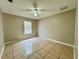 Bedroom featuring tile flooring, a ceiling fan, and natural light from the window at 306 Snook Way, Kissimmee, FL 34759