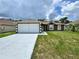 Inviting single-Gathering home featuring a clean white garage door and neutral earth tone color palette at 306 Snook Way, Kissimmee, FL 34759