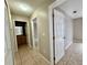 Hallway with tile flooring leading to bathroom and bedroom at 306 Snook Way, Kissimmee, FL 34759