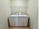 Laundry room with a washer, dryer, and wire shelving at 306 Snook Way, Kissimmee, FL 34759