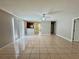 Open living area with tile flooring, fan, and view into other rooms at 306 Snook Way, Kissimmee, FL 34759